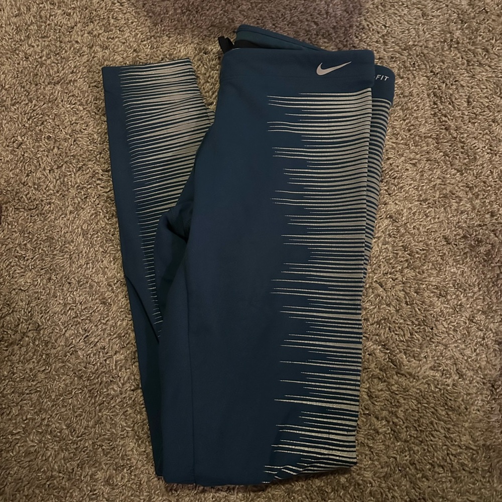 Blue Nike dry fit leggings. With reflectors